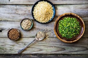 Peas,brown rice,quinoa and buckwheat on wooden background